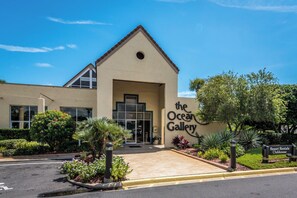 A building with a sign reading "the Ocean Gallery" and a sign for "Resort Rentals Clubhouse". - Perfect family getaway...steps from pool and beach!!! (Saint Augustine)