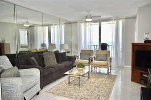 A modern living room with a sofa, armchairs, a coffee table, and a TV. - Perfect Location in Ponce Inlet for this 2/2 oceanfront Condo 504 South Point (Ponce Inlet)