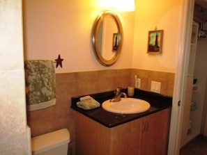 A bathroom with a sink, mirror, and toilet. - 7th Floor Unit 709 Oceanfront with Great Views in Ponce Inlet (Ponce Inlet)