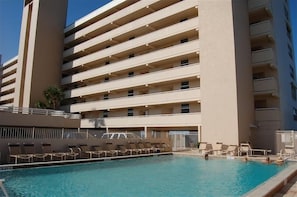 A multi-story hotel with a swimming pool and sun loungers. - 7th Floor Unit 709 Oceanfront with Great Views in Ponce Inlet (Ponce Inlet)