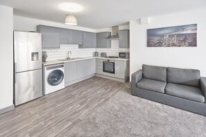 Enjoy cooking in this well-equipped kitchen with a gas stove, microwave, and washing machine.