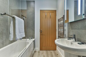 Bathtub, hair dryer, towels, soap