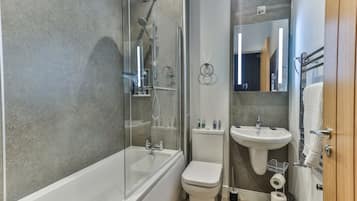 Bathtub, hair dryer, towels, soap