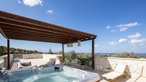 A rooftop patio with a hot tub, lounge chairs, and a pergola. - Mandana Villa - With Private Pool & Jacuzzi (Pigi)