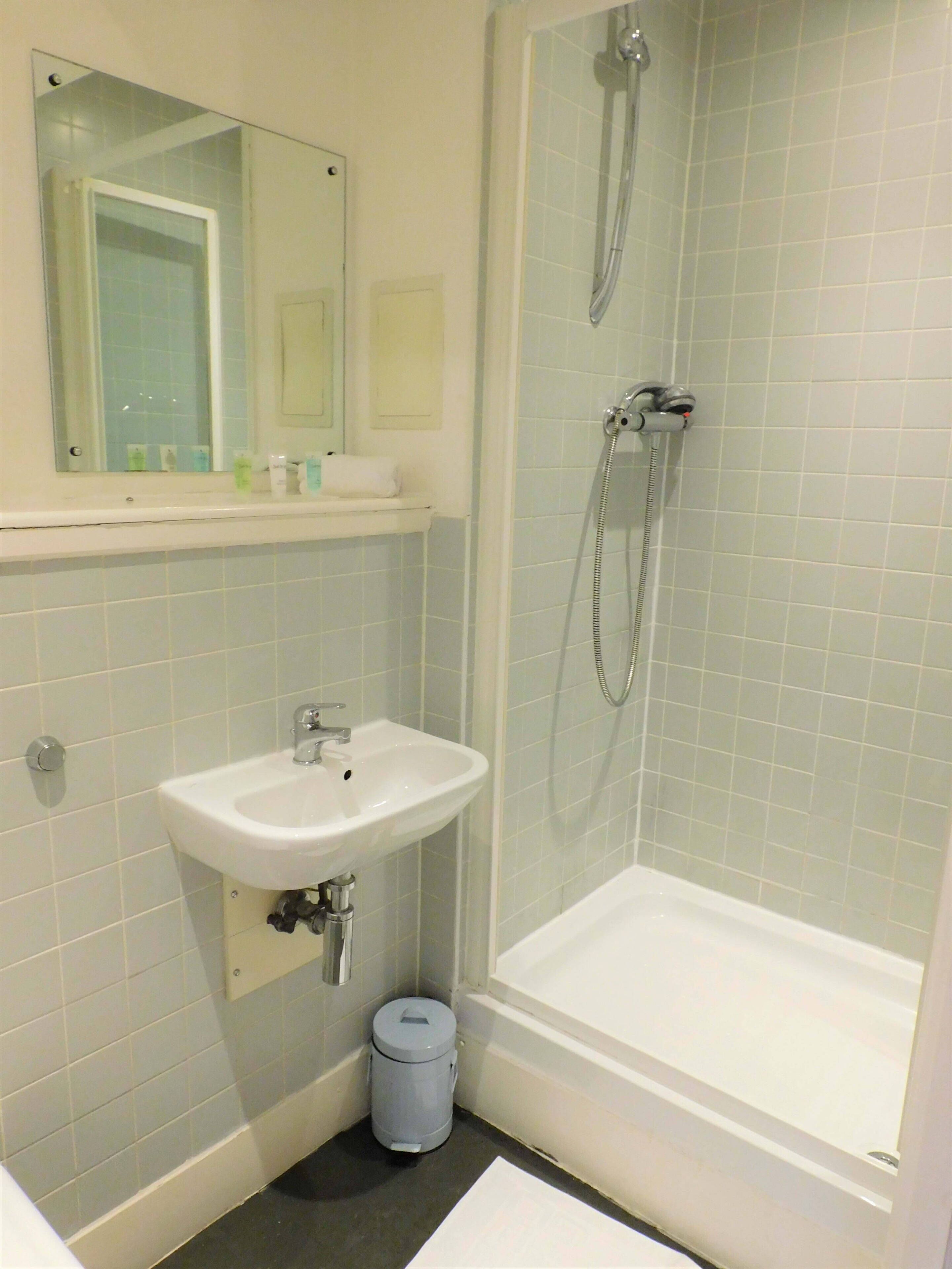 Bathtub, hair dryer, towels, shampoo