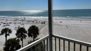 A beach view from a balcony with a railing, palm trees, and the ocean. - New to Rental market Luxury remodeled condo located directly on Siesta Key Beach (Sarasota)