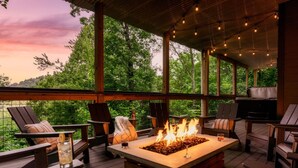 An outdoor deck with a fire pit, seating, and a view of the forest. - Hot Tub/Game Room/Theater/Fire Pit/VIEWS/Luxury! - Ski View Lodge (Gatlinburg)