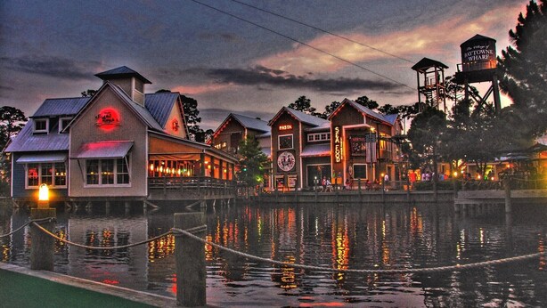 A waterfront restaurant with a sign for 'The Wharf' and 'Seafood'. - Beachy Sandestin studio, walk to Baytowne Wharf (Miramar Beach)