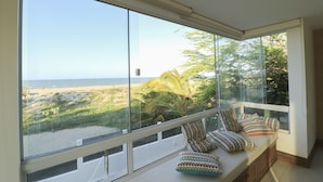 A room with a large window overlooking a beach and vegetation. - Beach Front Exclusive Villa with Pool (SAO MIGUEL DO GOSTOSO)