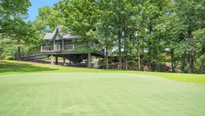 A golf course with a clubhouse and a bridge. - Rustic Log Cabin Near Thunder Ridge w Private Hot Tub & Free Attraction Tickets_Community Amenities! (Ridgedale)