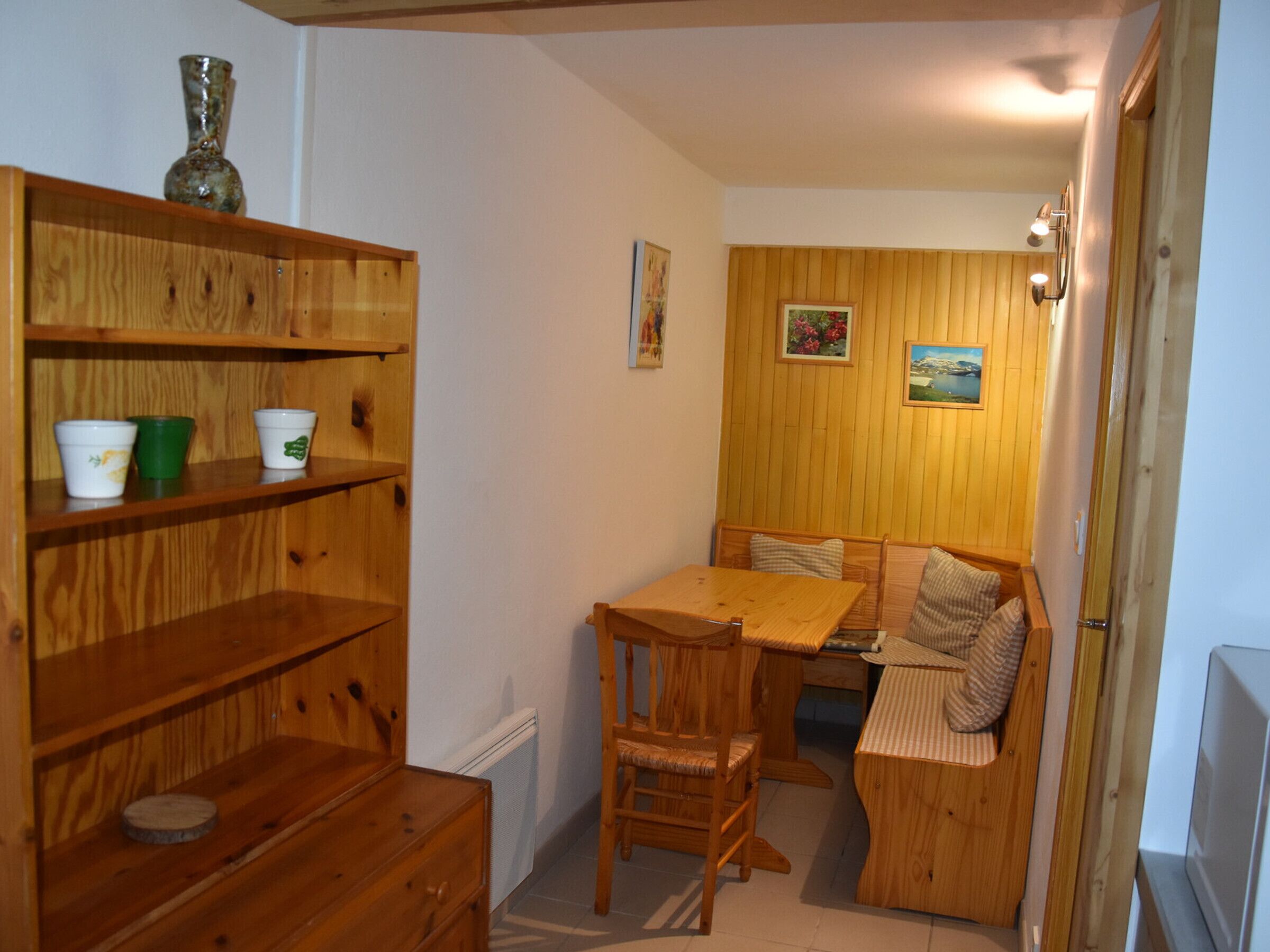 Una habitación acogedora con muebles de madera, una mesa de comedor y bancos.