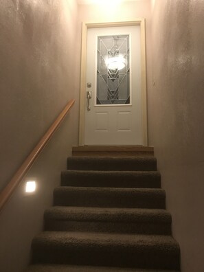 A staircase leading to a door with a geometric glass design. - Stunning home with huge game room plenty of space for relaxing and fun.Sleeps 14 (Angola)