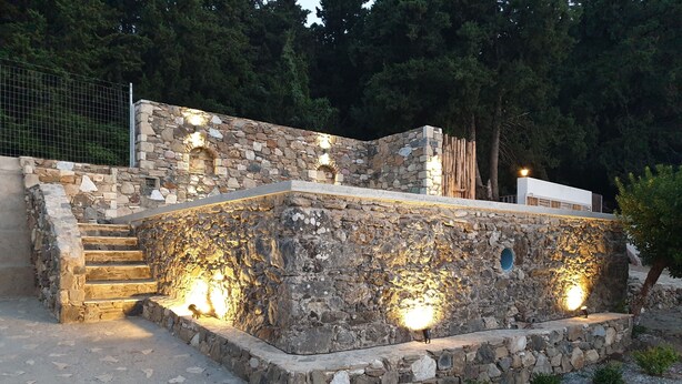 A stone structure with steps leading up to it, surrounded by trees. - Chaihoutes stone villa into Olive farm in Zia (Kos)