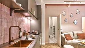 A modern kitchen with a large sink, stainless steel faucet, and a wine bottle on the counter. - NEW! Eiffel Tour Splendid 2BR apt in Paris (Paris)