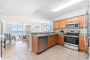A modern kitchen with granite countertops, stainless steel appliances, and wooden cabinets.