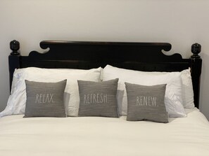 A bed with white and gray pillows, each with a word on them. - Family friendly, dog friendly, waterfront beach house (Longbranch)