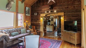 A cozy cabin interior with a sofa, television, wooden walls, and a star decoration. - The Lodge at Joe Walker Hollow, privacy at its best with plenty of family space (Middlebrook)