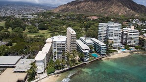 A coastal cityscape with a prominent mountain in the background, modern high-rise buildings, and a beach area. - A Gem of a Studio at The Diamond Head Beach Hotel (Honolulu)