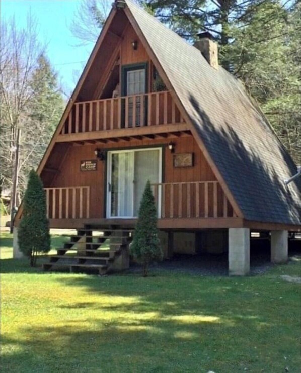 A wooden cabin with a front porch, a second-story balcony, and a chimney. - Private Rustic A-Frame in the Heart of Elk Country (Benezette)
