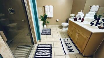 Bathtub, hair dryer, towels, toilet paper