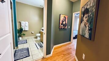 Bathtub, hair dryer, towels, toilet paper