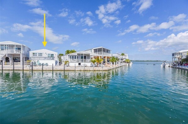 Overlooking a calm body of water, this property offers scenic views from its large windows and open spaces.