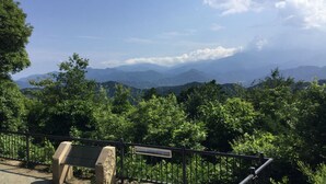 A park bench overlooking a mountainous landscape. - Toyoko Inn Tokyo Akishima-eki Minami-guchi (Akishima)