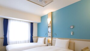 A hotel room with two beds, a large window with curtains, a wall-mounted heater, and a clock. - Toyoko Inn Tokyo Akishima-eki Minami-guchi (Akishima)