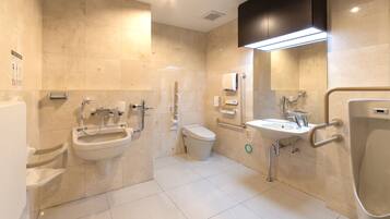 A modern bathroom with a bidet, toilet, and sink.