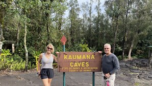 A sign for Kaumana Caves with a forested background. - Poolside Cozy 1br, 1Qbed plus 1QSofa bed, Med refrig, sm kitchen,2min to Ocean (Kailua-Kona)