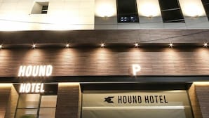 The exterior of the Hound Hotel with illuminated signage and a modern facade. - Hound Hotel Sasang (Busan)