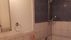 A bathroom with a sink, toilet, and bathtub.