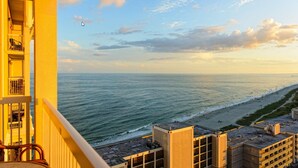 A balcony overlooking a beach with a clear sky and ocean view. - Westgate Myrtle Beach Oceanfront 828-94 (Myrtle Beach)