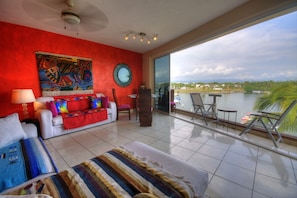 Relax in this inviting space with a panoramic view of the water and distant buildings.