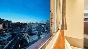 A cityscape view from a hotel room window, including buildings and a train track. - Rakuten STAY Naha Yachimun Street (Naha)