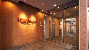 A hotel entrance with a sign reading "Rakuten Stay" and a glass door leading inside. - Rakuten STAY Naha Yachimun Street (Naha)