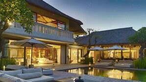 A luxurious outdoor lounge area with a pool, comfortable seating, and a well-lit interior space. - Kaba Kaba Estate (Cepaka)