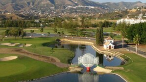 A golf course with a pond, a gazebo, and a mountain backdrop. - Beautiful villa with private pool and garden (Mijas)