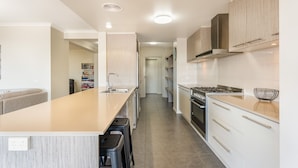 A modern kitchen with a central island, stainless steel appliances, and a minimalist design.