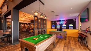 A pool table in a room with a bar area, arcade games, and a seating area with tables and chairs. - St Osyth- Sleeps8-freeparking-wifi-holidaypark (Clacton-on-Sea)