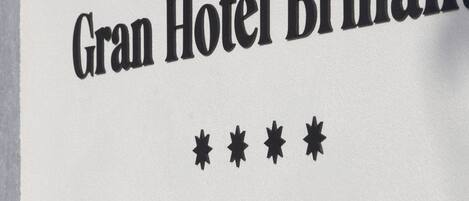 A sign with "Gran Hotel Brillant" and "HOTEL BOUTIQUE" text, indicating a hotel boutique.