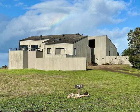 A modern two-story building with a flat roof and a concrete facade.