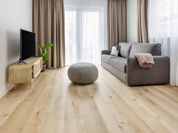Deluxe Suite with Balcony | Living area | TV