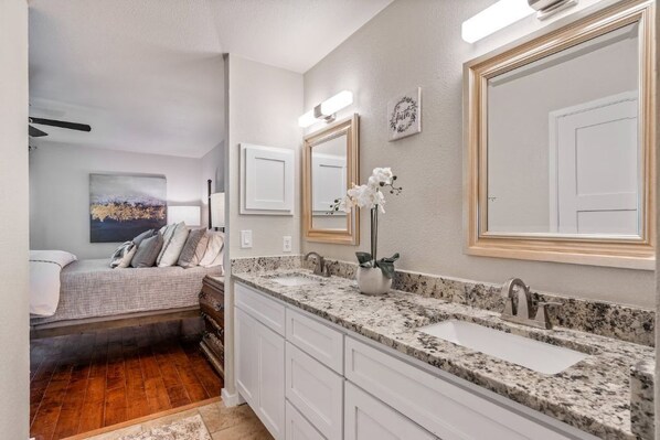 A bathroom with a double sink, large mirrors, and a vanity with drawers. - Single Story Home. Walk to shops and restaurants (Bedford)