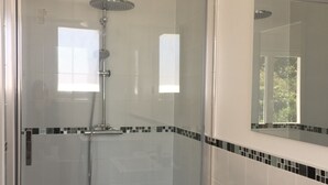 A modern bathroom with a glass-enclosed shower, a white sink, and a mirror above the sink. - Suite**** in charming 19th century residence with park and heated swimming pool (Arvert)