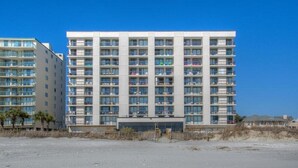 A modern multi-story hotel with a uniform facade, numerous balconies, and a flat roof. - Waterpointe II 806-3BR/2BA Oceanfront Condo in Windy Hill (North Myrtle Beach)