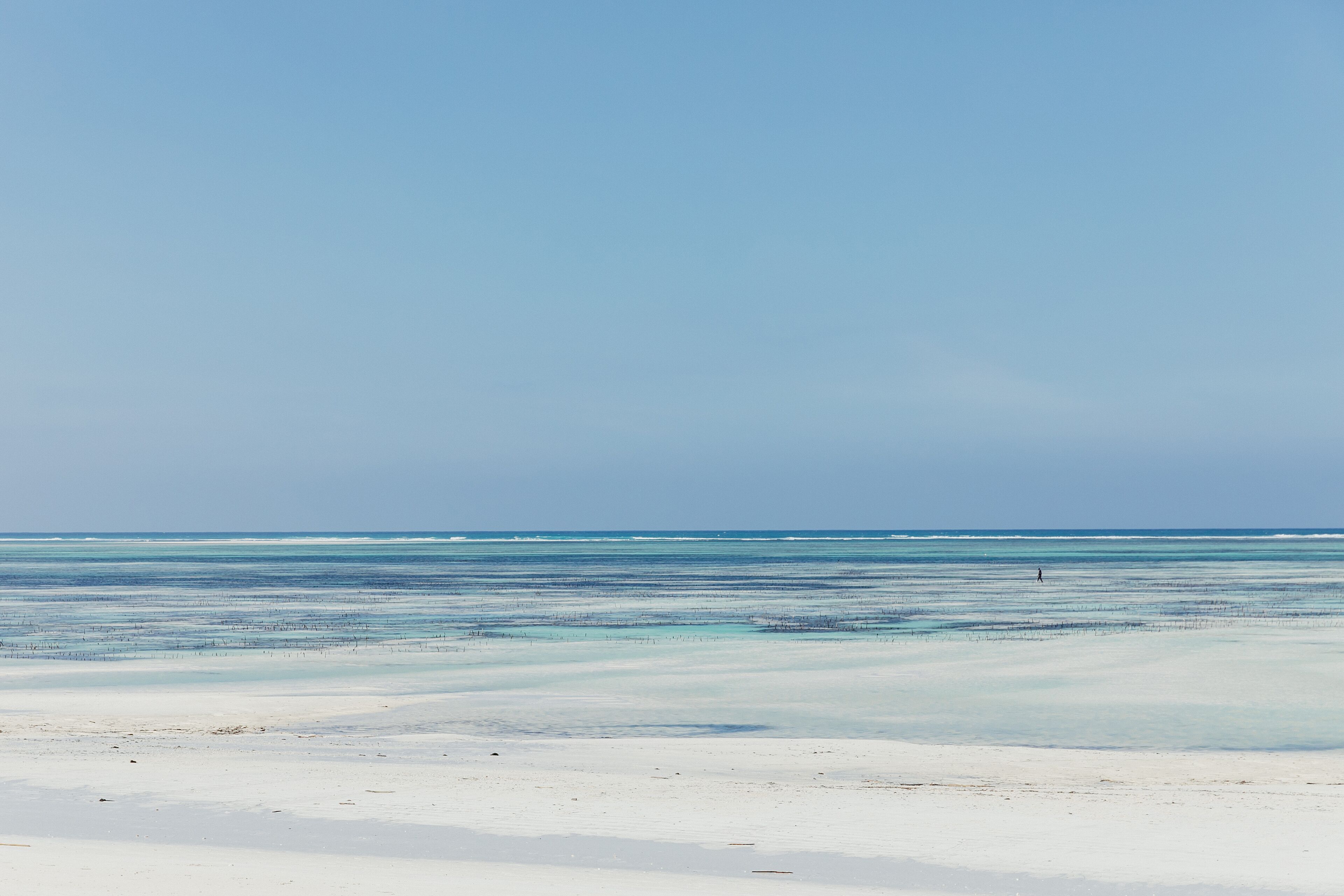 A beach with clear skies and calm waters.
