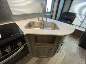 Mobile Home (Givens Glamper- 2021 Heartland W/thre) | Private kitchen - Givens Glamper Heartland W 3 Beds, Outdoor Pool, Views for Days (Branson)