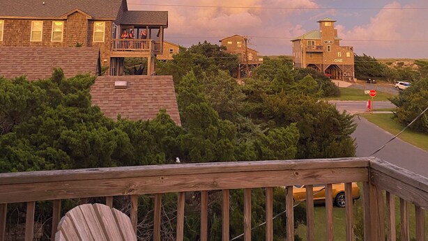 A residential area with houses, a stop sign, and a wooden deck. - Avon NC OBX Dog-Friendly Home  - Short walk to the Beach or Sound - PARK PLACE (Avon)