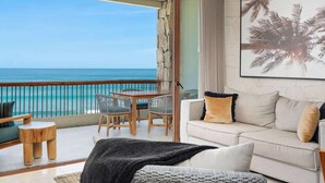 A balcony with a view of the ocean, a dining table, and a sofa with cushions. - Oceanfront  Condo at Costa Azul Beach ! (San José del Cabo)